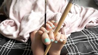 Friend tickles my soles with painting brushes. Close up feet worship